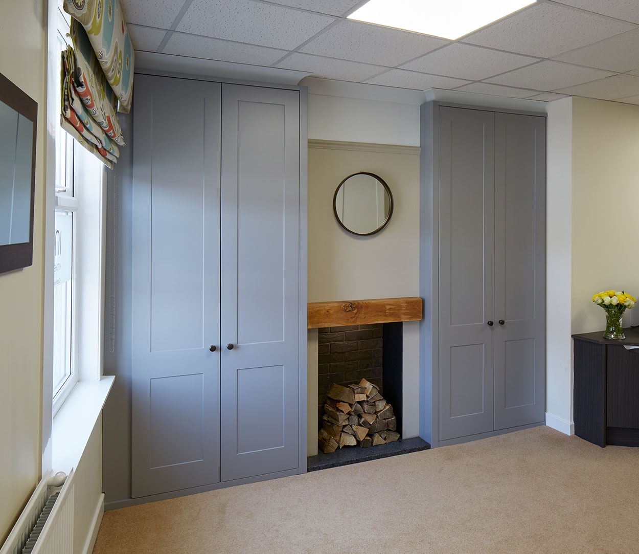 Photograph of a modern light coloured bedroom wardrobe, integrated into the wall.